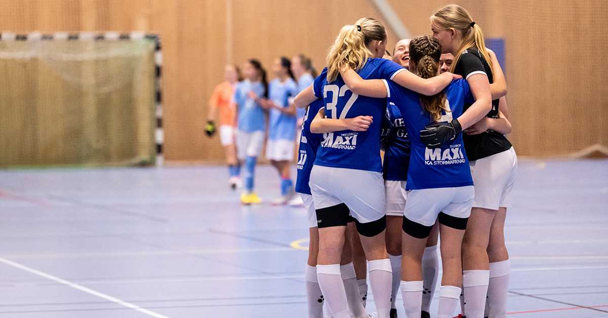 Ett idrottslag med unga tjejer kramar om varandra